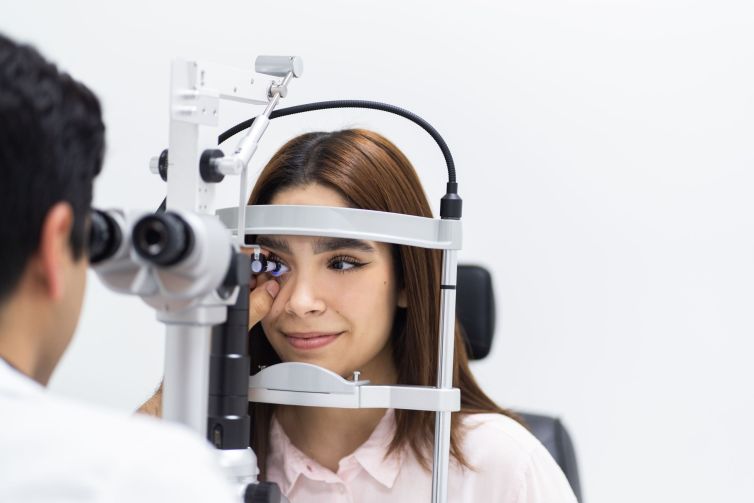 Young woman getting her eyes checked by ophthalmologist