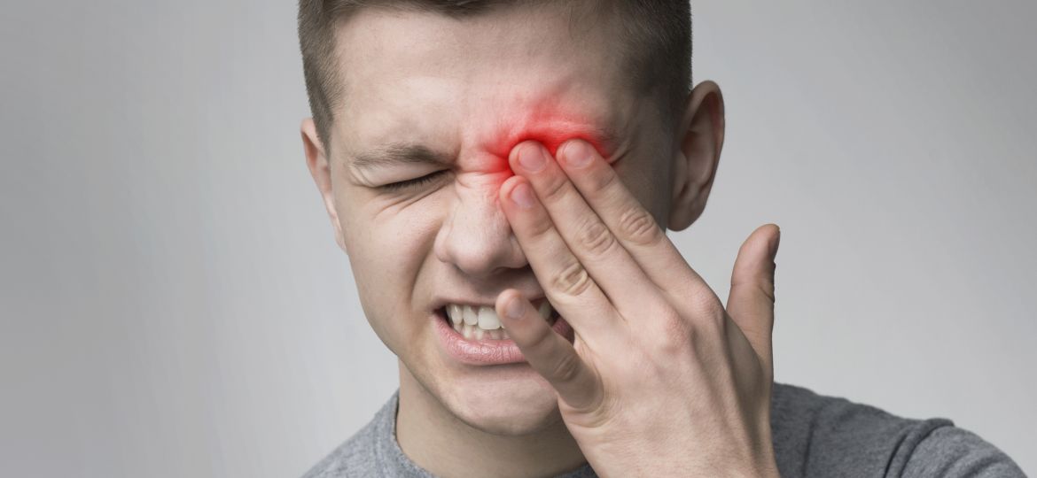 Upset man suffering from strong eye pain