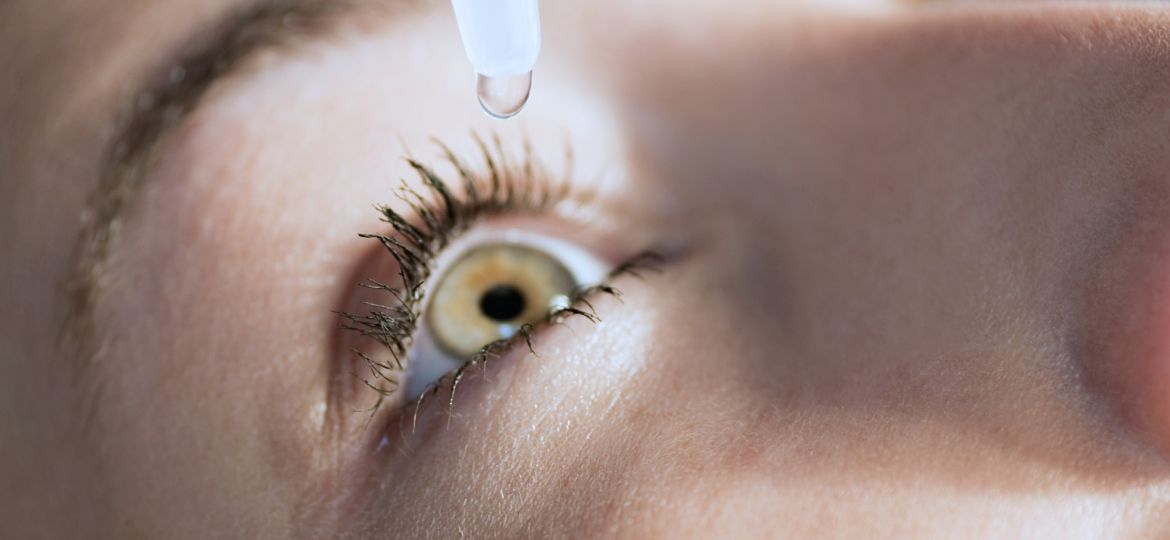 Eyedropper releasing fluid into an eye