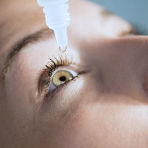 Eyedropper releasing fluid into an eye